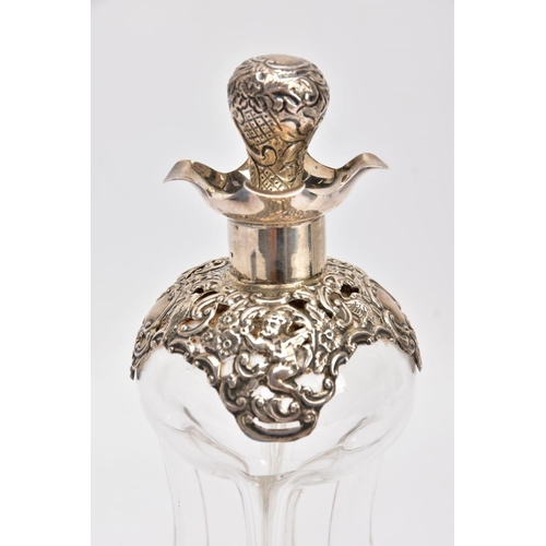 18 - AN EDWARDIAN GLASS AND SILVER DECANTER, the hour glass bottle with silver collar and stopper embosse... 