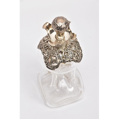 18 - AN EDWARDIAN GLASS AND SILVER DECANTER, the hour glass bottle with silver collar and stopper embosse... 