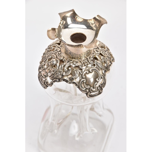 18 - AN EDWARDIAN GLASS AND SILVER DECANTER, the hour glass bottle with silver collar and stopper embosse... 