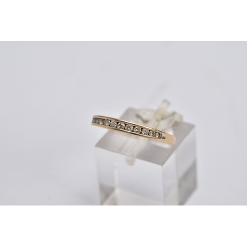 23 - TWO 9CT GOLD DIAMOND RINGS, the first of a half eternity design, set with a row of graduated channel... 