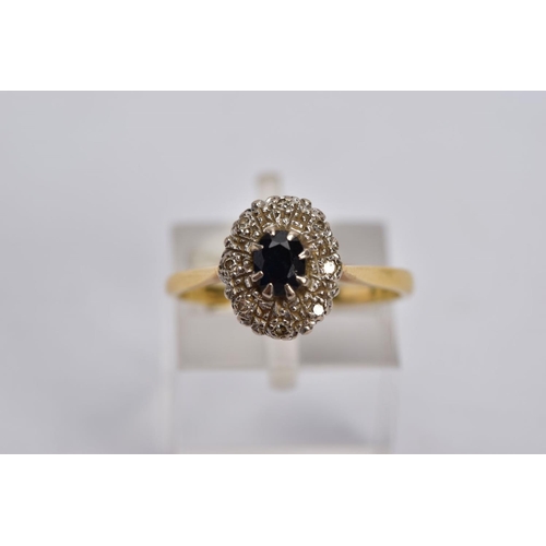 27 - A YELLOW METAL SAPPHIRE AND DIAMOND CLUSTER RING, designed with a central oval cut blue sapphire, wi... 