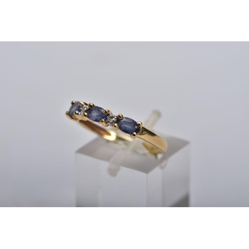 29 - A 9CT GOLD IOLITE AND DIAMOND RING AND A FULL ETERNITY RING, the first designed with three oval cut ... 