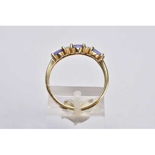 29 - A 9CT GOLD IOLITE AND DIAMOND RING AND A FULL ETERNITY RING, the first designed with three oval cut ... 