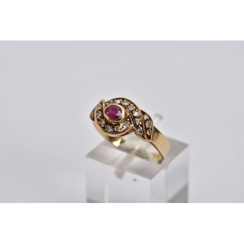 51 - A YELLOW METAL RUBY AND DIAMOND CLUSTER RING, centring on an oval cut ruby, within a single cut diam... 