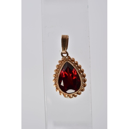 55 - A 9CT GOLD GARNET PENDANT AND FOUR OTHER YELLOW METAL PENDANTS, the first set with a pear cut garnet... 