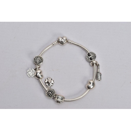 58 - A PANDORA CHARM BRACELET, snake chain bracelet fitted with nine charms in forms such as an openwork ... 