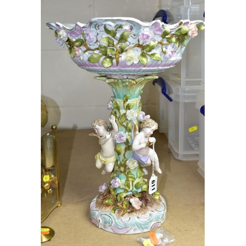 611 - A CONTINENTAL TABLE CENTRE PIECE, having pierced basket bowl decorated with roses, standing on a ped... 