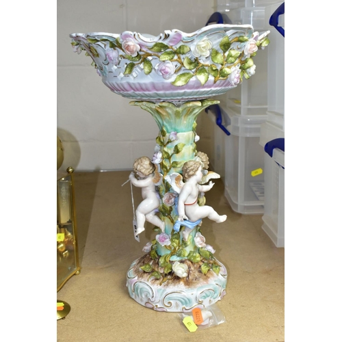 611 - A CONTINENTAL TABLE CENTRE PIECE, having pierced basket bowl decorated with roses, standing on a ped... 