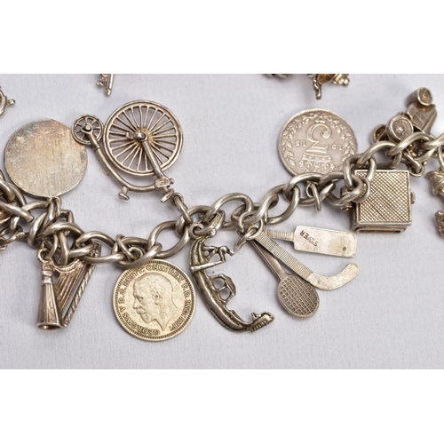 64 - TWO CHARM BRACELETS, the first suspending eight white metal charms in forms such as a bible, church,... 