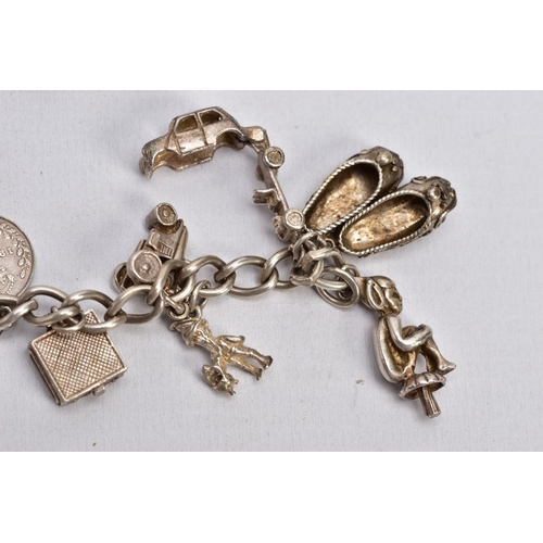 64 - TWO CHARM BRACELETS, the first suspending eight white metal charms in forms such as a bible, church,... 