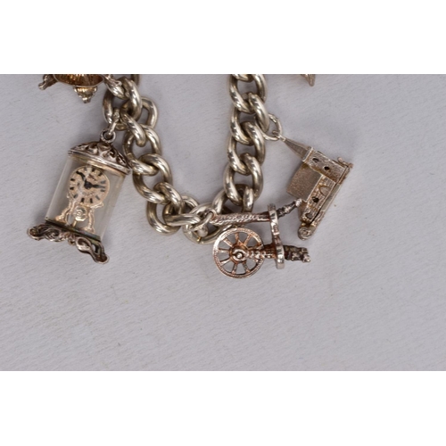 64 - TWO CHARM BRACELETS, the first suspending eight white metal charms in forms such as a bible, church,... 