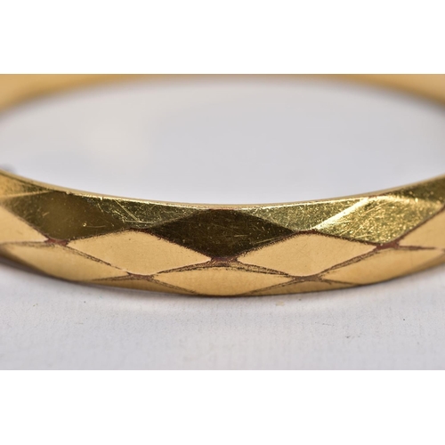 66 - TWO ROLLED GOLD HINGED BANGLES, one with an engraved floral design, the other with a textured design... 