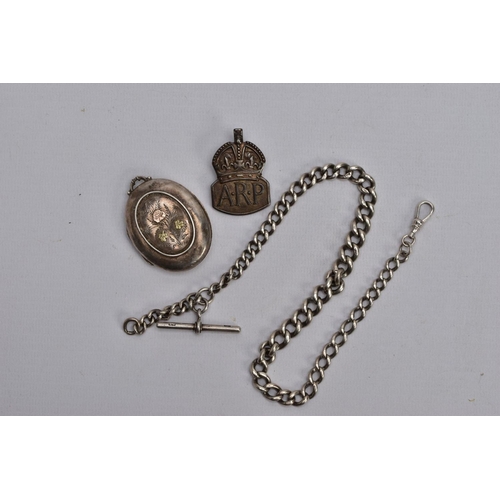 69 - A VICTORIAN SILVER LOCKET, A SILVER ALBERT CHAIN AND AN A.R.P. BADGE, the a.f. Locket of an oval for... 