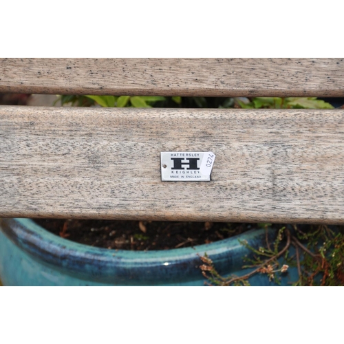 1032 - A TEAK GARDEN BENCH with pegged plant sides and wide slatted seat and back Badged Hattersley, Keighl... 