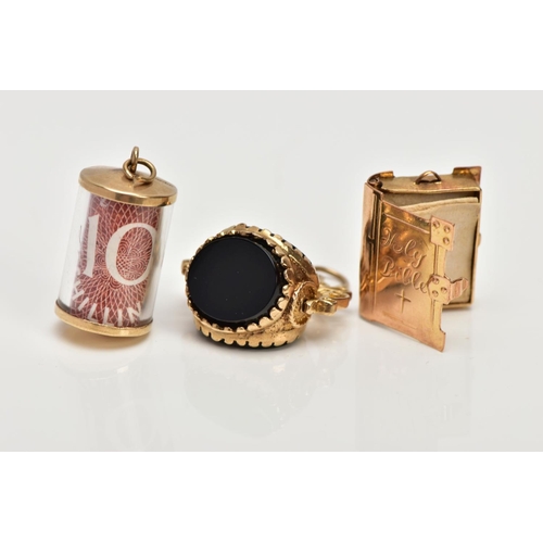 117 - THREE 9CT GOLD CHARMS, to include a 9ct gold swivel charm set with onyx and bloodstone panels, a 9ct... 