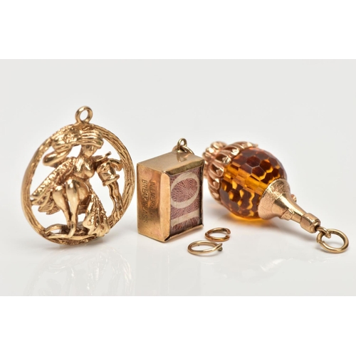 119 - THREE 9CT GOLD CHARMS, to include a wine bottle charm with faceted orange glass bead body, an encase... 