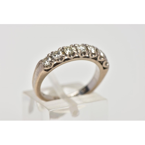 13 - A WHITE METAL DIAMOND HALF ETERNITY RING, designed with a row of claw set round brilliant cut diamon... 