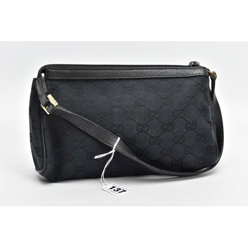 137 - A SMALL BLACK GUCCI BAG, the monogram canvas with brass fittings and zip closure, inner label stampe... 