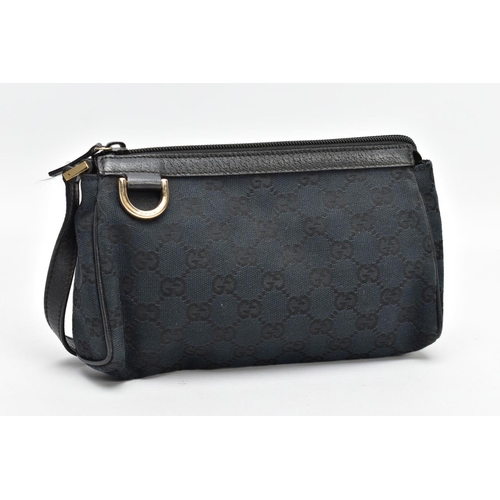 137 - A SMALL BLACK GUCCI BAG, the monogram canvas with brass fittings and zip closure, inner label stampe... 
