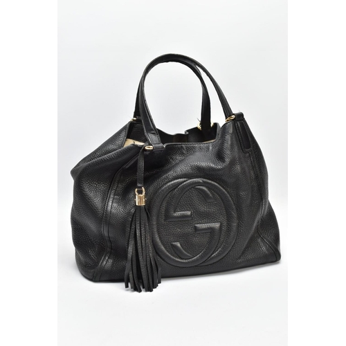 139 - A BLACK GUCCI BAG, the soft leather with raised double G symbol to front centre, tassel attached to ... 