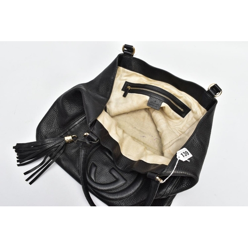 139 - A BLACK GUCCI BAG, the soft leather with raised double G symbol to front centre, tassel attached to ... 