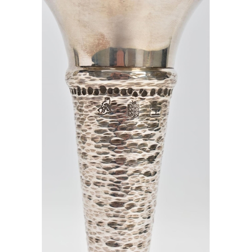 144 - A SILVER STEM VASE, of conical form with hammered detail, flared undulating rim and a weighted base,... 