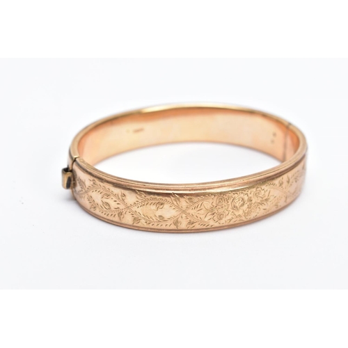 160 - A 9CT GOLD OVAL HALF ENGRAVED OVAL HINGED BANGLE, half engraved with a floral and foliate fancy desi... 