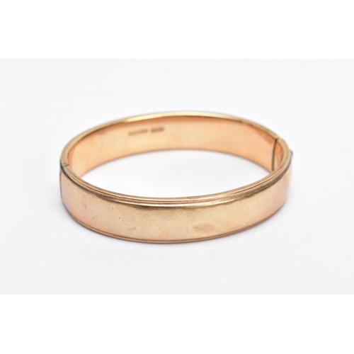 160 - A 9CT GOLD OVAL HALF ENGRAVED OVAL HINGED BANGLE, half engraved with a floral and foliate fancy desi... 