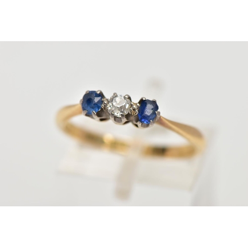 17 - A YELLOW METAL THREE STONE RING, designed with a central, claw set old cut diamond, flanked with cla... 