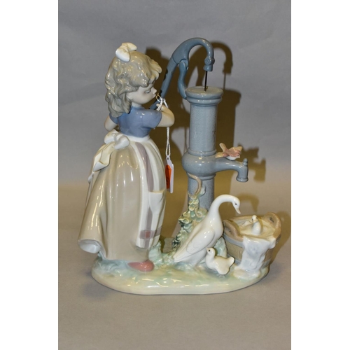 302 - A LLADRO FIGURE GROUP SUMMER ON THE FARM, model no 5285, depicting a girl and birds at a water pump,... 