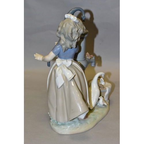 302 - A LLADRO FIGURE GROUP SUMMER ON THE FARM, model no 5285, depicting a girl and birds at a water pump,... 