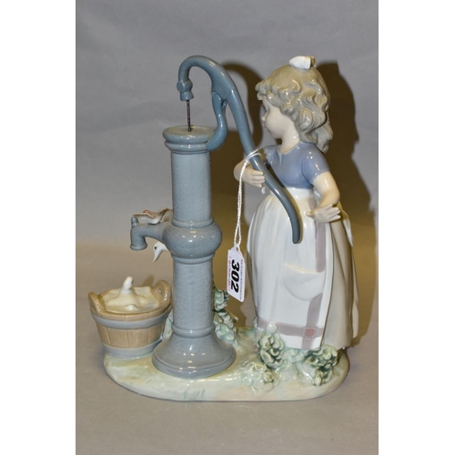 302 - A LLADRO FIGURE GROUP SUMMER ON THE FARM, model no 5285, depicting a girl and birds at a water pump,... 