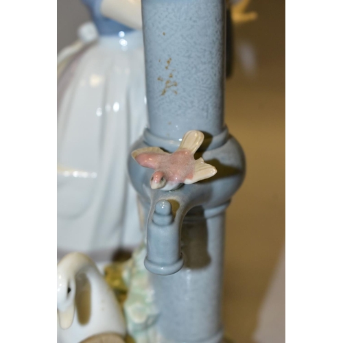 302 - A LLADRO FIGURE GROUP SUMMER ON THE FARM, model no 5285, depicting a girl and birds at a water pump,... 