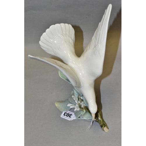 303 - A LLADRO TURTLE DOVE, model no 4550, perched on leaves with wings raised, designed by Fulgencio Garc... 