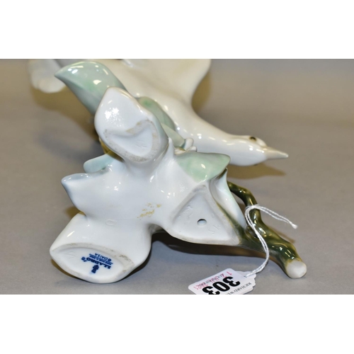 303 - A LLADRO TURTLE DOVE, model no 4550, perched on leaves with wings raised, designed by Fulgencio Garc... 