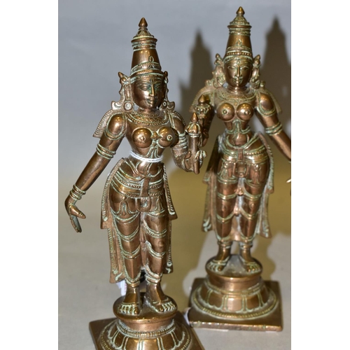 309 - A NEAR PAIR OF BRONZE FIGURES OF PARVATI HOLDING A LOTUS FLOWER, cast on a circular plinth with squa... 