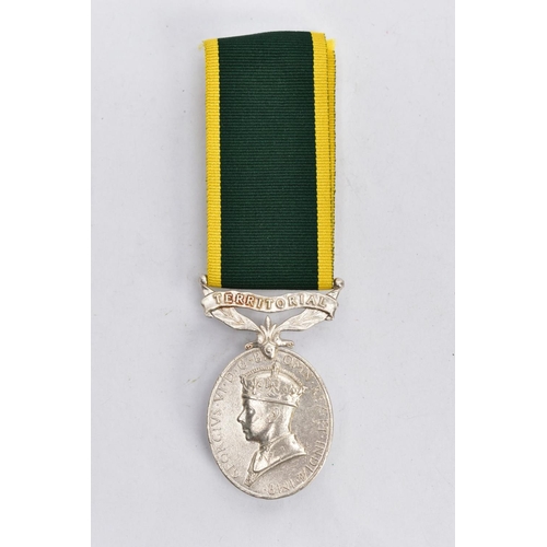 37 - A GEORGE VI TERRITORIAL EFFICIENCY MEDAL, the oval medal suspended from a green and yellow ribbon, l... 