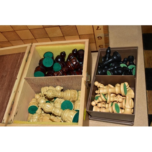 538 - A WOODEN CHESS BOARD AND A QUANTITY OF WOODEN AND RESIN CHESS SETS, including two resin sets formed ... 