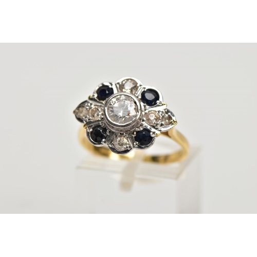 69 - AN 18CT GOLD DIAMOND AND SAPPHIRE CLUSTER RING, the central brilliant cut diamond within a collet se... 