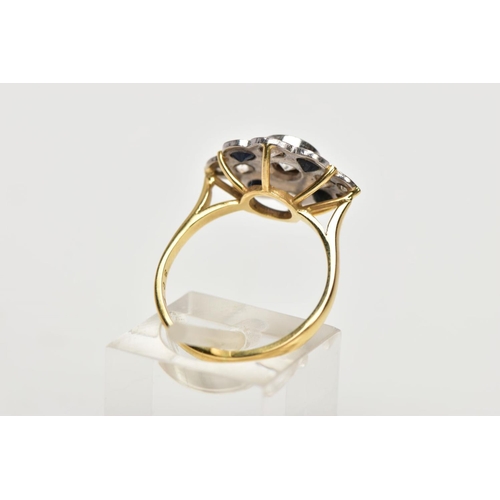 69 - AN 18CT GOLD DIAMOND AND SAPPHIRE CLUSTER RING, the central brilliant cut diamond within a collet se... 
