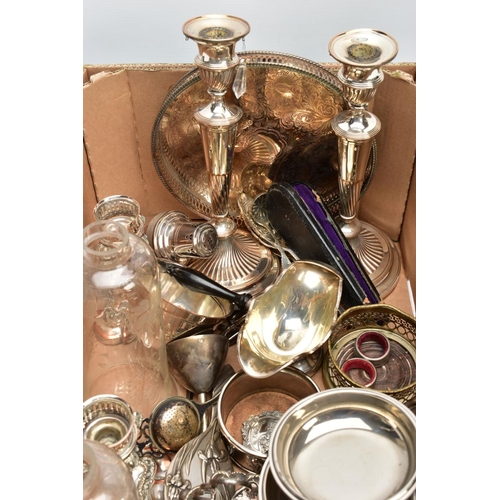 88 - A LARGE BOX OF SILVER PLATED METALWARE, to include a pair of candlesticks, weighted stepped bases, s... 