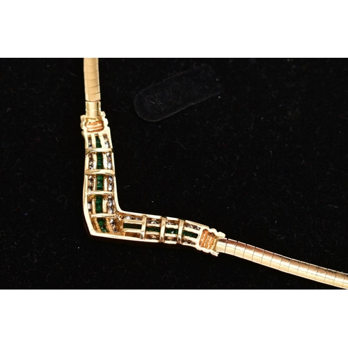12 - AN EMERALD AND DIAMOND COLLAR NECKLACE, the V-shape central panel channel set with a central line of... 