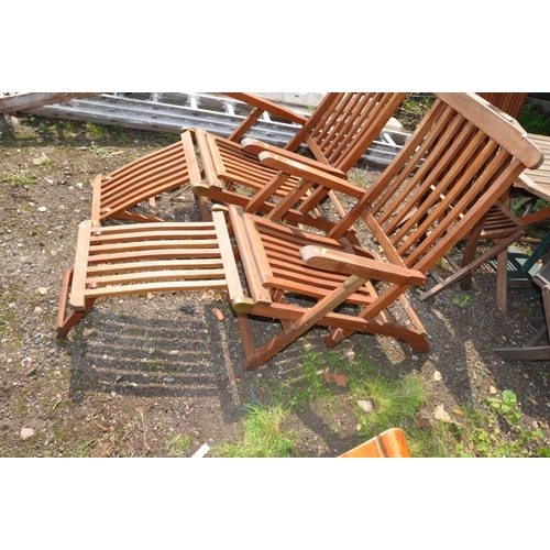 1002 - A PAIR OF MODERN FOLDING HARDWOOD STEAMER CHAIRS with footrests and brass fittings (2)