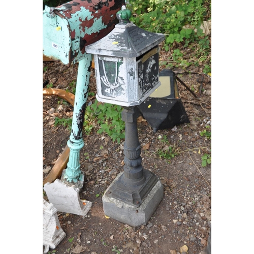 1007 - AN AMERICAN STYLE MAILBOX attached to a cast iron Corinthian column base and concrete foot 134cm hig... 