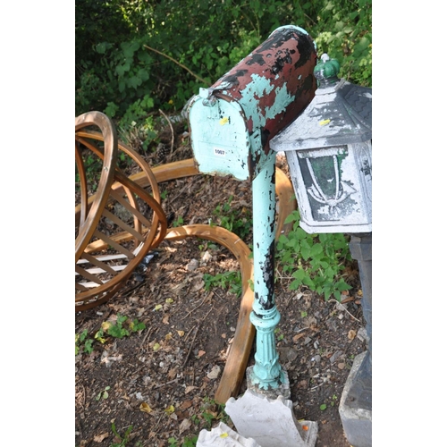 1007 - AN AMERICAN STYLE MAILBOX attached to a cast iron Corinthian column base and concrete foot 134cm hig... 