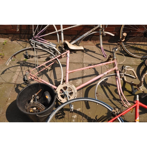 1032 - A COLLECTION OF VINTAGE BIKES AND PARTS including two Raleigh Ladies racing bike frames, an Apollo a... 