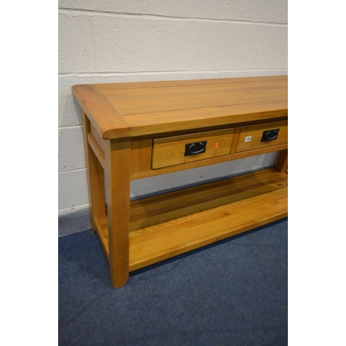 1198 - A SOLID OAK SIDE TABLE with three drawers, block legs united by an undershelf, width 150cm x depth 4... 