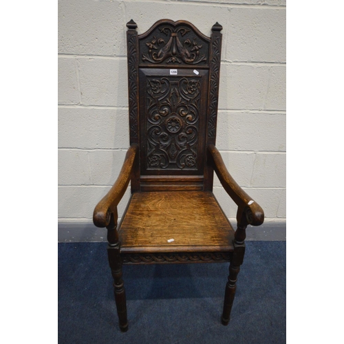 1206 - A 19TH CENTURY CARVED OAK WAINSCOT CHAIR, foliate carved back, solid seat and open armrests, width 5... 