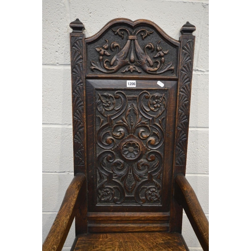 1206 - A 19TH CENTURY CARVED OAK WAINSCOT CHAIR, foliate carved back, solid seat and open armrests, width 5... 