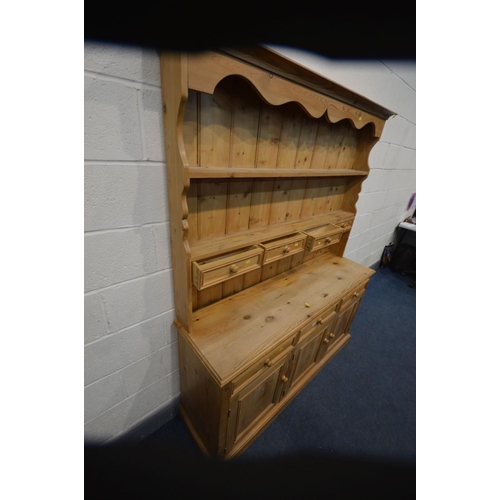 1212 - A PINE DRESSER with seven assorted drawers and triple cupboard doors, width 153cm x depth 43cm x hei... 